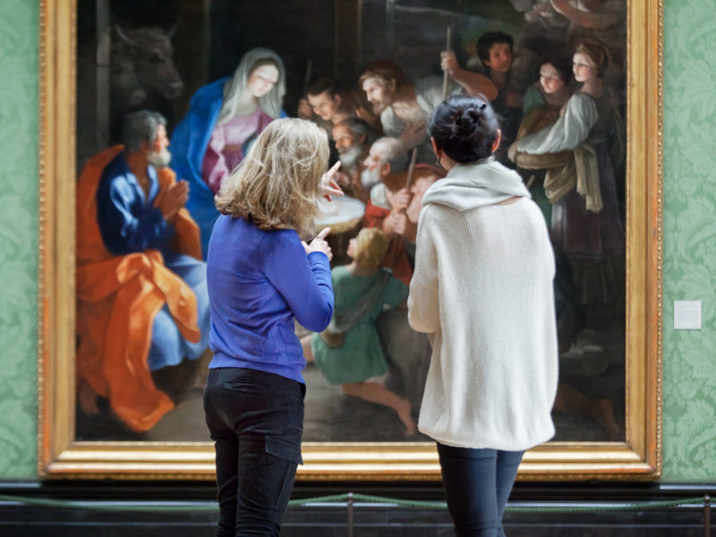 Visitors looking at a painting in the National Gallery